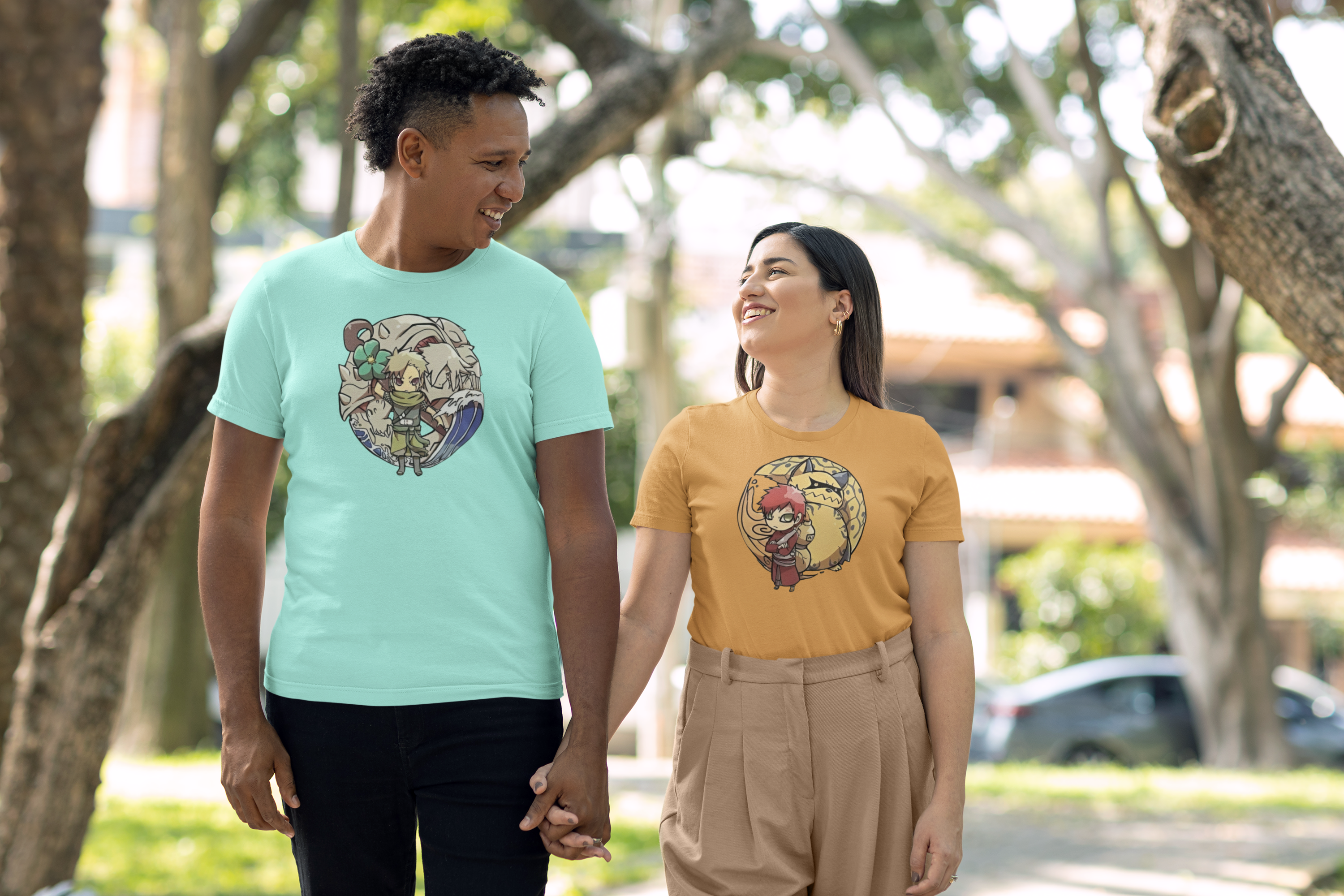 Two people walking hand in hand, both wearing t-shirts with a graphic design.