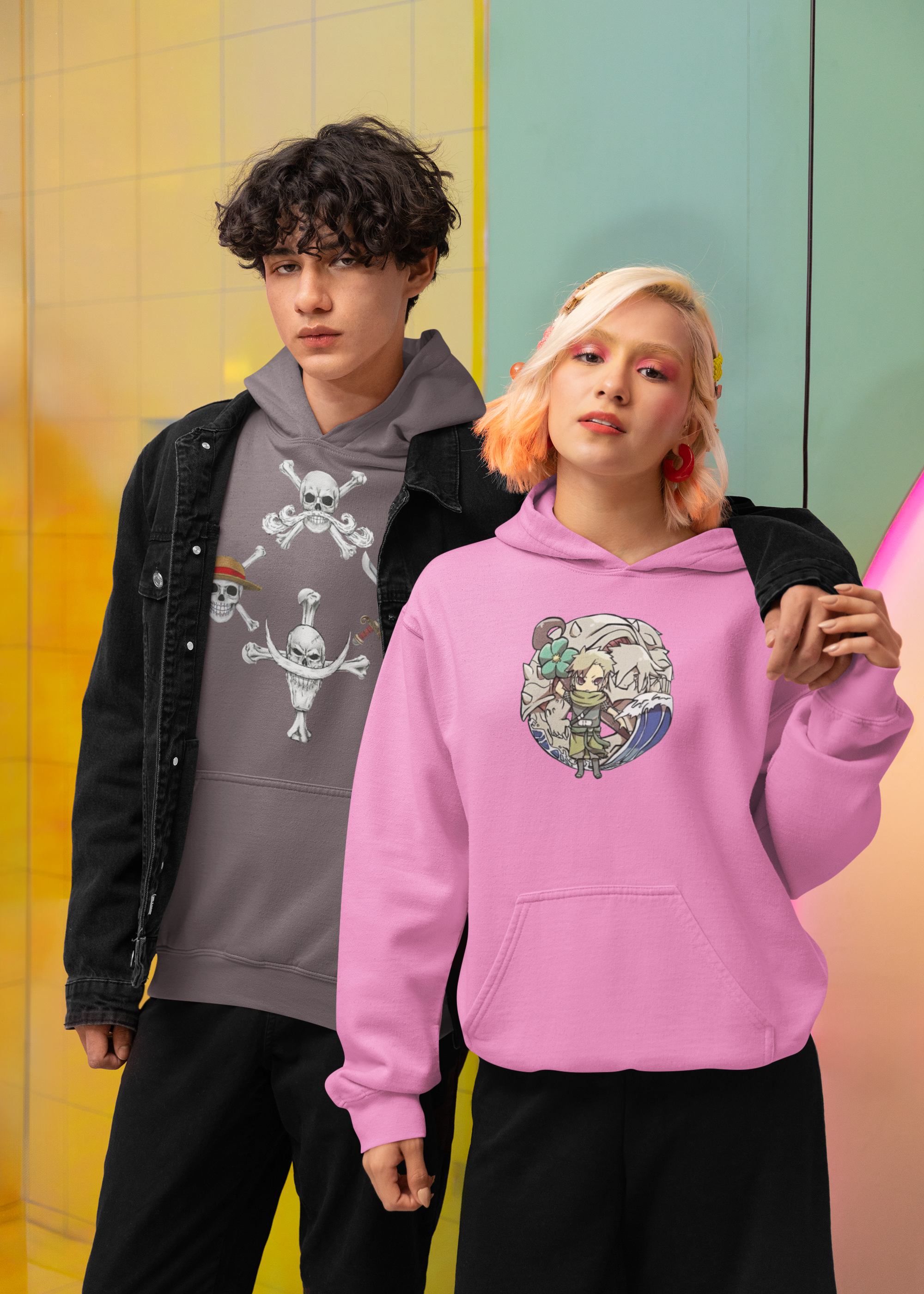 Two people wearing hoodies with graphic designs against a colorful background